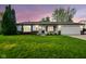 Charming single-story home featuring a well-manicured lawn, attached garage, and inviting front porch at 155 Suncrest Dr, Greenwood, IN 46143