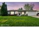 Charming single-story home featuring a well-manicured lawn, attached garage, and inviting front porch at 155 Suncrest Dr, Greenwood, IN 46143