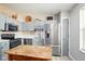 Well-lit kitchen boasts modern stainless-steel appliances and stylish light blue cabinets at 155 Suncrest Dr, Greenwood, IN 46143