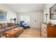 Inviting living room with a sofa, blue armchair, and wooden floors, creating a warm and welcoming atmosphere at 155 Suncrest Dr, Greenwood, IN 46143