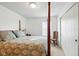 Main bedroom features a four poster bed and soft natural light creating a calm, peaceful retreat at 155 Suncrest Dr, Greenwood, IN 46143