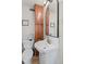 Efficient bathroom featuring a toilet, sink with storage, large mirror, and cabinet space at 17 W Washington St, Mooresville, IN 46158