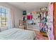 Bright bedroom featuring built-in closet shelving, natural light from the window, and hardwood floors at 17 W Washington St, Mooresville, IN 46158