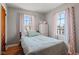 Charming bedroom featuring hardwood floors, natural light, and a comfortable bed at 17 W Washington St, Mooresville, IN 46158