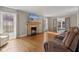 Bright living room with a cozy fireplace and hardwood floors, perfect for relaxing and entertaining at 17 W Washington St, Mooresville, IN 46158