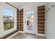 Sun room featuring wood paneled walls and trim, and a glass panel door with a view of the backyard at 17 W Washington St, Mooresville, IN 46158