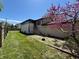 Charming backyard featuring a lush lawn, blooming tree, tall fence, and convenient sunroom access at 1705 Witt Rd, Lebanon, IN 46052