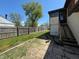 Well-maintained backyard featuring a spacious yard, tall wooden fence, and steps to a sunroom at 1705 Witt Rd, Lebanon, IN 46052