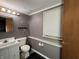 Modest bathroom with a toilet, sink and vanity, overhead lighting, and a mirror at 1705 Witt Rd, Lebanon, IN 46052
