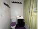 Modest bathroom featuring a toilet, vanity sink, and shower with green curtains at 1705 Witt Rd, Lebanon, IN 46052