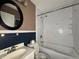Bathroom with a toilet, sink, large mirror, and bathtub with showerhead at 1705 Witt Rd, Lebanon, IN 46052
