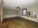Living room featuring hardwood floors, ceiling fan, and built-in mirror at 1705 Witt Rd, Lebanon, IN 46052