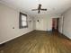 Living room featuring hardwood floors, ceiling fan, window and a doorway into the next room at 1705 Witt Rd, Lebanon, IN 46052