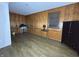 Empty room with wood paneled walls, wood floors, window, and several pieces of furniture at 1705 Witt Rd, Lebanon, IN 46052