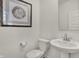 A half bathroom with a pedestal sink and wood-themed artwork at 2138 Foothill Dr, Greenfield, IN 46140