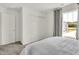 Bright bedroom featuring a window with patterned curtains, closet with sliding doors, and plush carpeting at 2138 Foothill Dr, Greenfield, IN 46140