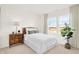 Bright bedroom with white paneling, a comfortable bed, and a large window with natural light at 2215 Boxwood Dr, Greenfield, IN 46140