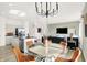 Open-concept living showcases a dining area with a glass-top table and seamless flow to the kitchen and living room at 2215 Boxwood Dr, Greenfield, IN 46140