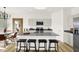 Bright and airy kitchen with an island, modern appliances and a view into the dining area at 2215 Boxwood Dr, Greenfield, IN 46140