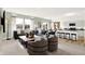 Spacious living room with large windows, plush seating, and an open-concept design connecting to the kitchen at 2215 Boxwood Dr, Greenfield, IN 46140