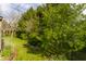 Lush backyard featuring a well-maintained lawn and mature trees for privacy and shade at 2236 Calaveras Way, Indianapolis, IN 46240