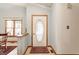 Bright entryway featuring a decorative glass door, tile flooring, and a view into the dining area at 2236 Calaveras Way, Indianapolis, IN 46240