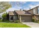 Inviting townhouse featuring stone accents, a two-car garage, and a neatly kept lawn at 2236 Calaveras Way, Indianapolis, IN 46240