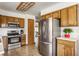 Full kitchen view with modern stainless steel appliances and classic wood cabinets at 2236 Calaveras Way, Indianapolis, IN 46240