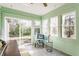 Bright sunroom with tile flooring, large windows, and a view of the lush outdoor space at 2236 Calaveras Way, Indianapolis, IN 46240