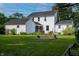 Spacious backyard featuring a screened-in porch, lush greenery, and mature trees at 2405 Sycamore St, Columbus, IN 47201