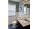Stylish bathroom features wainscoting, patterned floor, and modern fixtures at 2405 Sycamore St, Columbus, IN 47201