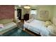 View of bedroom with hardwood floors, white bedframe, and brick accent wall at 2405 Sycamore St, Columbus, IN 47201