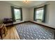 Bright bedroom with two windows, hardwood floors, and decorative rug at 2405 Sycamore St, Columbus, IN 47201