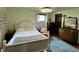 Bedroom with hardwood floors, white wood bedframe, and a blue rug at 2405 Sycamore St, Columbus, IN 47201