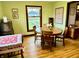 Green dining room with hardwood floors, natural lighting, and furniture creating a warm and inviting atmosphere for meals at 2405 Sycamore St, Columbus, IN 47201