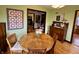 Cozy dining room with hardwood floors, vintage furniture, and a decorative quilt on the wall at 2405 Sycamore St, Columbus, IN 47201