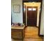 Charming entryway with hardwood floors, wooden door and a decorative rug at 2405 Sycamore St, Columbus, IN 47201