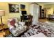Comfortable living area featuring a floral armchair, desk, and decorative accents, creating a cozy and stylish atmosphere at 2405 Sycamore St, Columbus, IN 47201