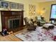 Cozy living room with a fireplace, area rug, hardwood floors, and ample seating, creating a warm and inviting space at 2405 Sycamore St, Columbus, IN 47201