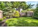 Backyard with green grass, mature trees and flower beds, perfect for relaxing and entertaining at 2512 E 57Th St, Indianapolis, IN 46220
