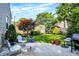 Well-manicured backyard with patio and lush landscaping offers an outdoor retreat at 2512 E 57Th St, Indianapolis, IN 46220