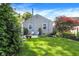 Lush backyard featuring a well-maintained lawn, patio, and shade trees, perfect for outdoor enjoyment at 2512 E 57Th St, Indianapolis, IN 46220