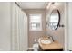Cozy bathroom with vanity, tile flooring, and shower with white curtain at 2512 E 57Th St, Indianapolis, IN 46220