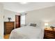 Bedroom featuring a double bed, neutral walls, hardwood floors, and a bright window at 2512 E 57Th St, Indianapolis, IN 46220