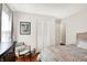 Well-lit bedroom featuring hardwood floors, comfortable seating, and closet space at 2512 E 57Th St, Indianapolis, IN 46220