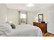 Well-lit bedroom with hardwood floors, neutral walls, and comfortable furnishings at 2512 E 57Th St, Indianapolis, IN 46220