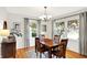 Bright dining room with hardwood floors, modern light fixture, and large windows with lovely neighborhood views at 2512 E 57Th St, Indianapolis, IN 46220
