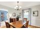 Comfortable dining room with hardwood floors, a chandelier, and views into adjacent rooms at 2512 E 57Th St, Indianapolis, IN 46220