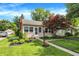 Attractive one-story home with lush green lawn, manicured bushes, and charming curb appeal at 2512 E 57Th St, Indianapolis, IN 46220