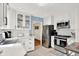 Modern kitchen with stainless steel appliances, white cabinets, and lots of counter space at 2512 E 57Th St, Indianapolis, IN 46220